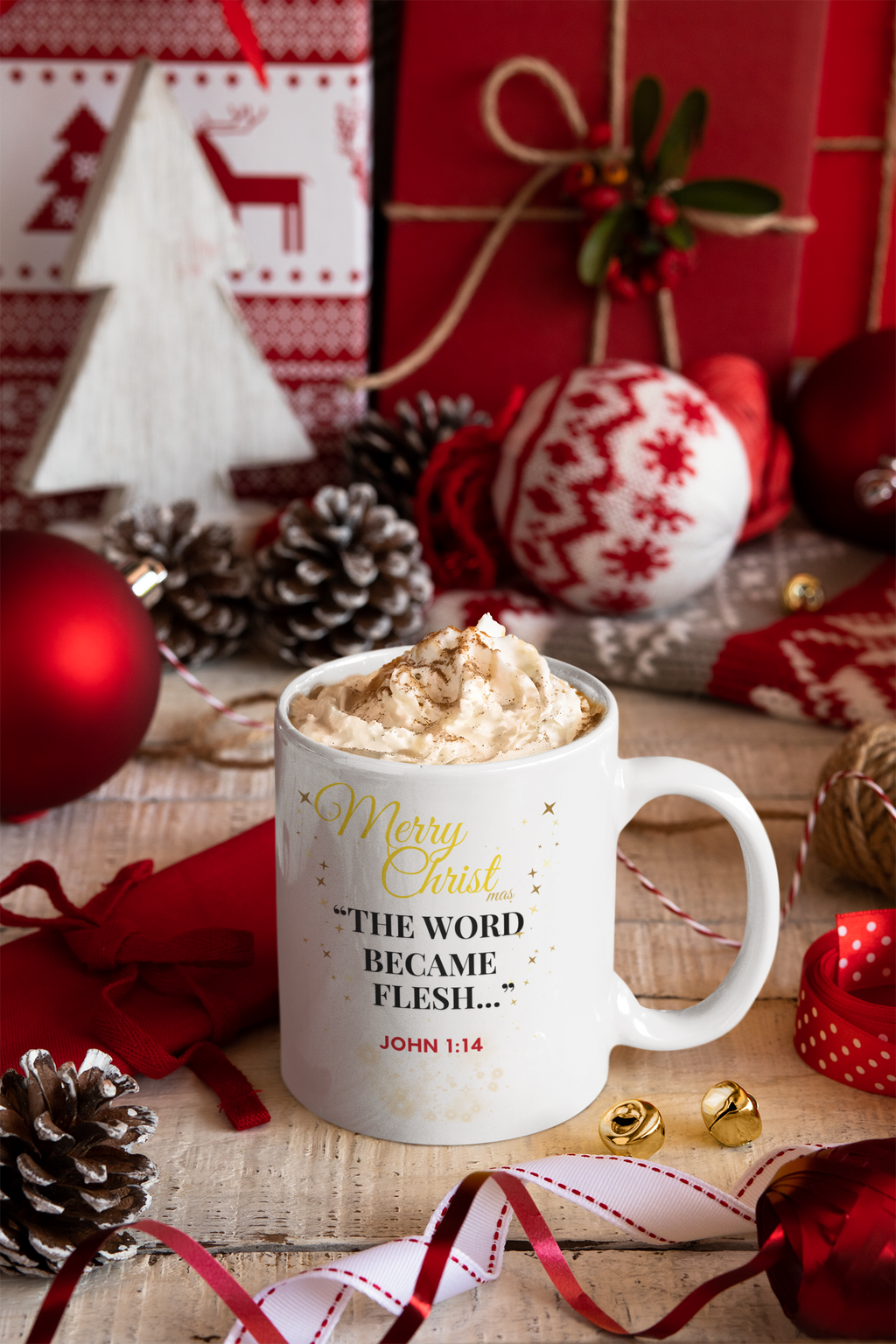 Mug with hot chocolate and whipped cream, surrounded by Christmas decorations on a wooden table.