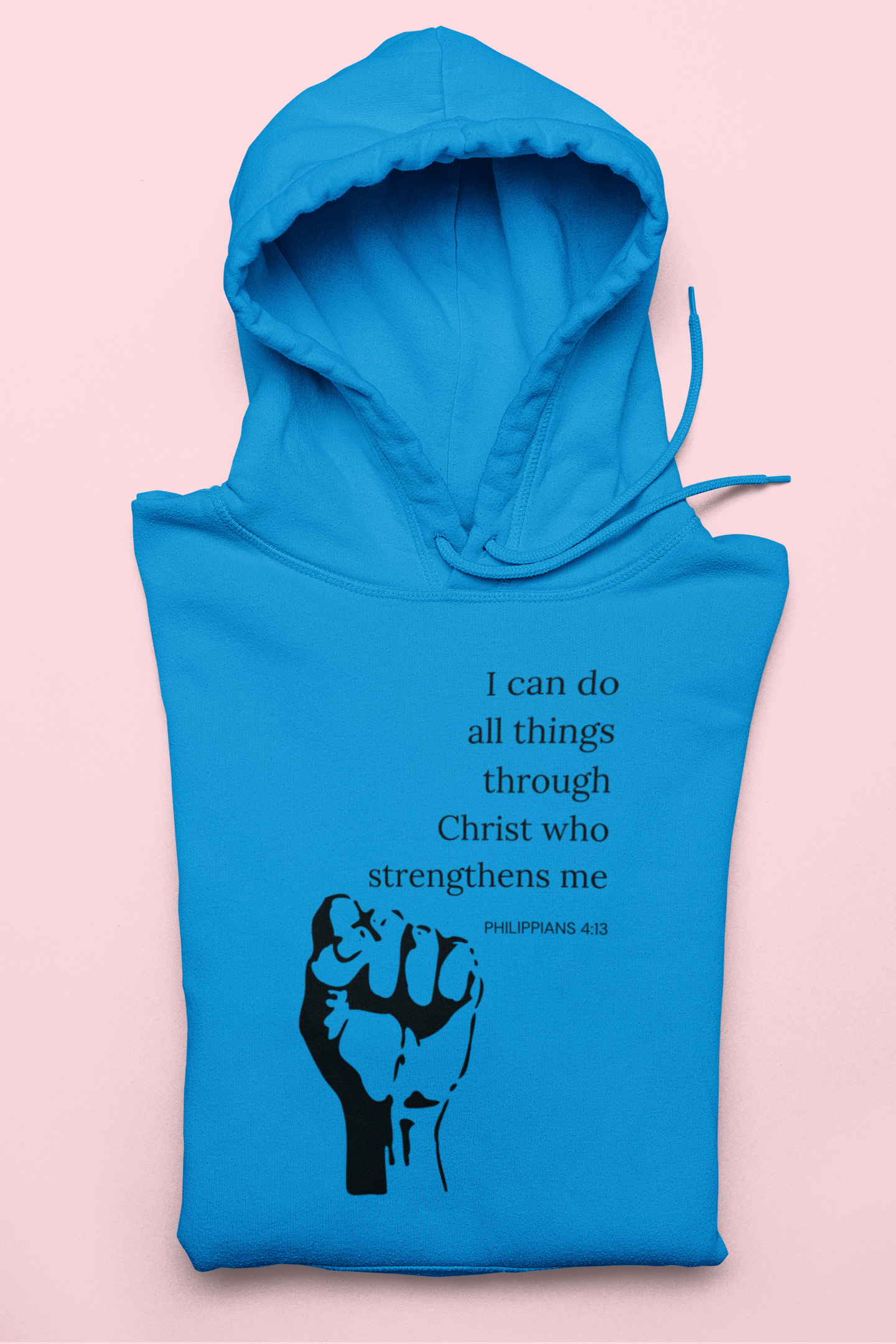 Blue hoodie with a black fist graphic and inspirational quote on a pink background