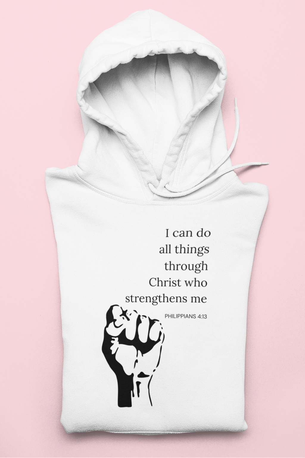 White hoodie with motivational quote and fist graphic on a pink background