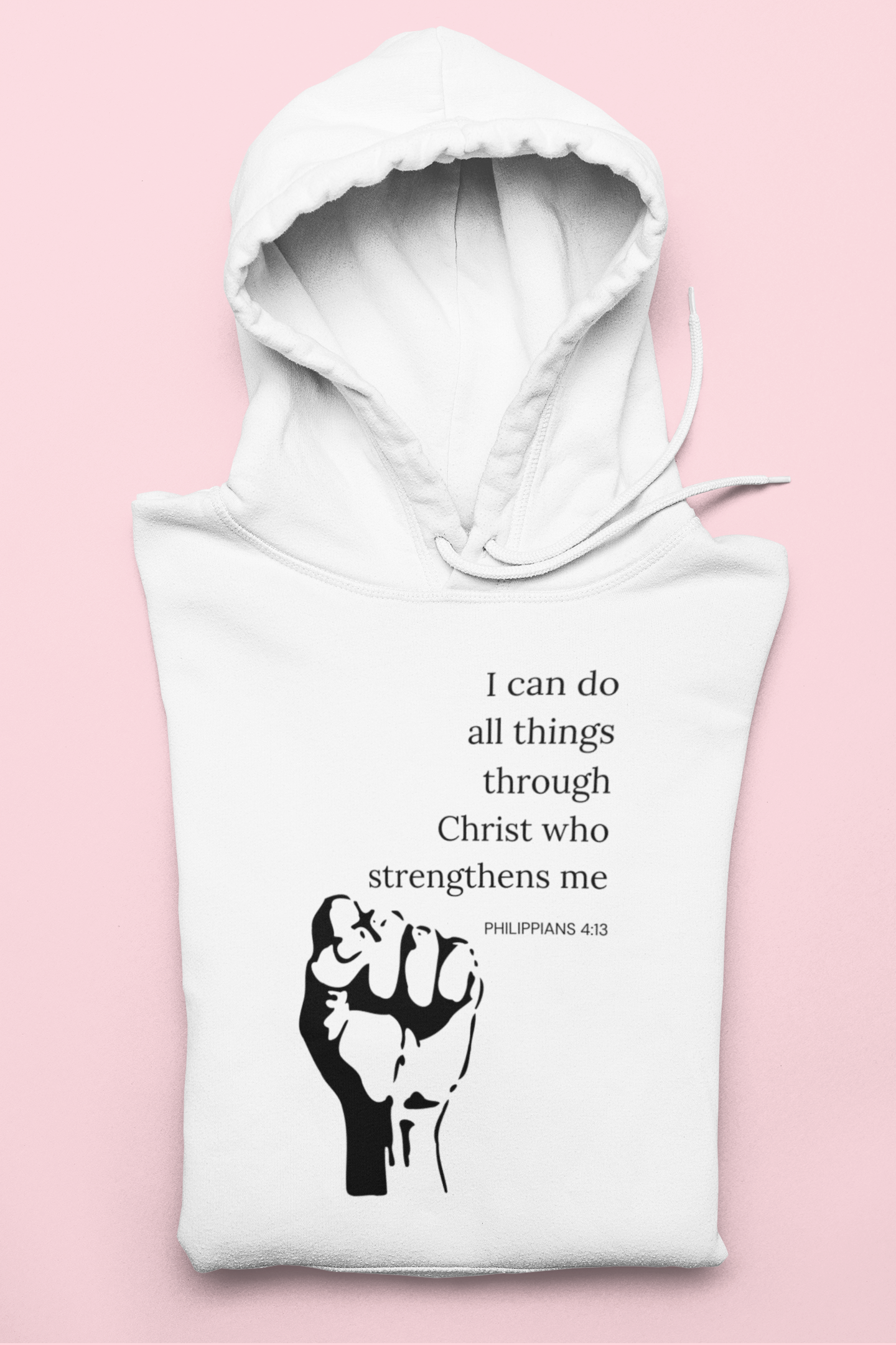 White hoodie with motivational quote and fist graphic on a pink background