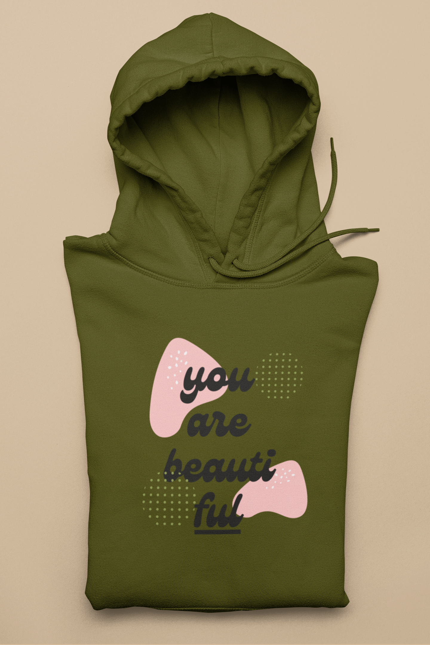 Green hoodie with 'you are beautiful' text on a beige background