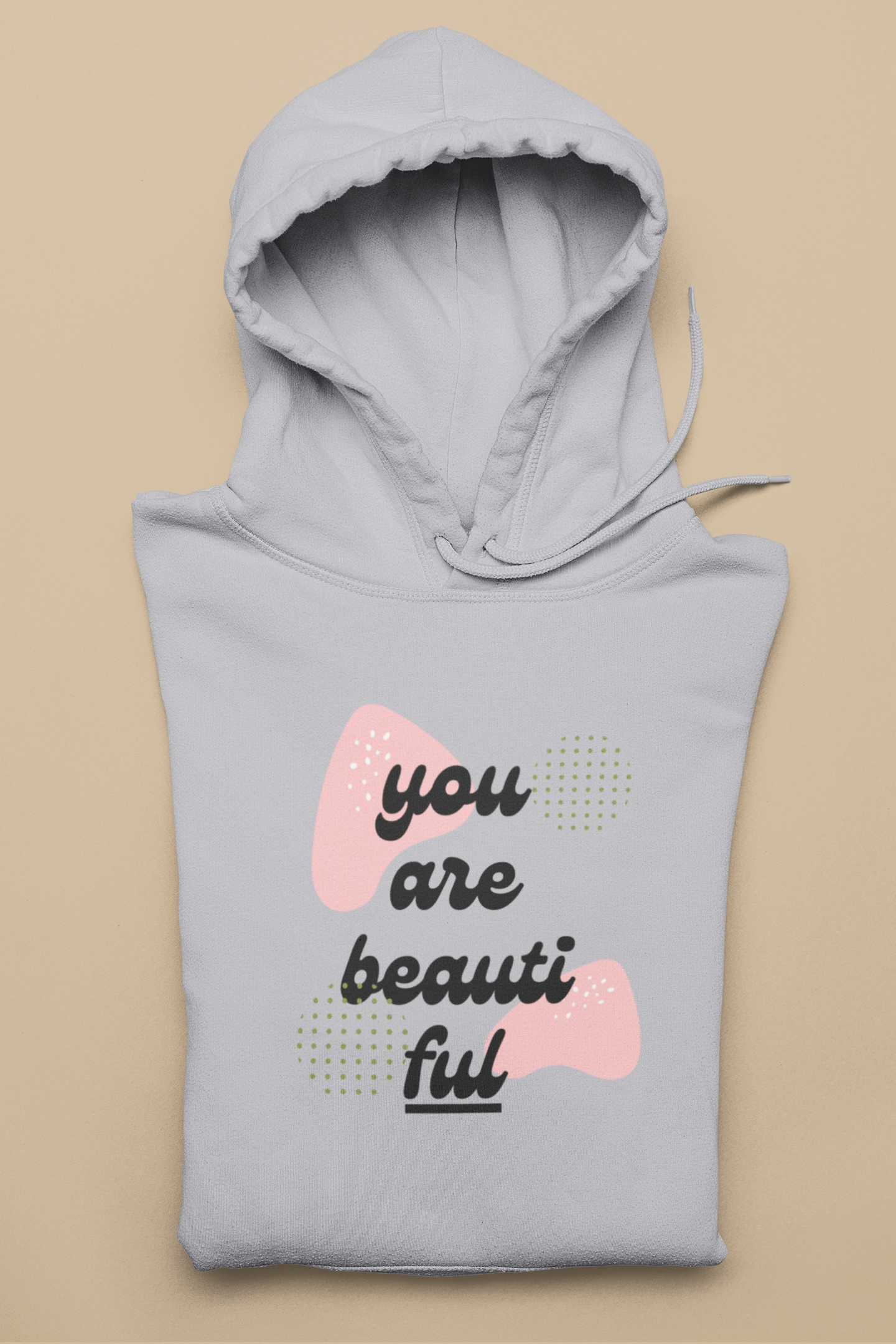 Gray hoodie with 'you are beautiful' text on a beige background