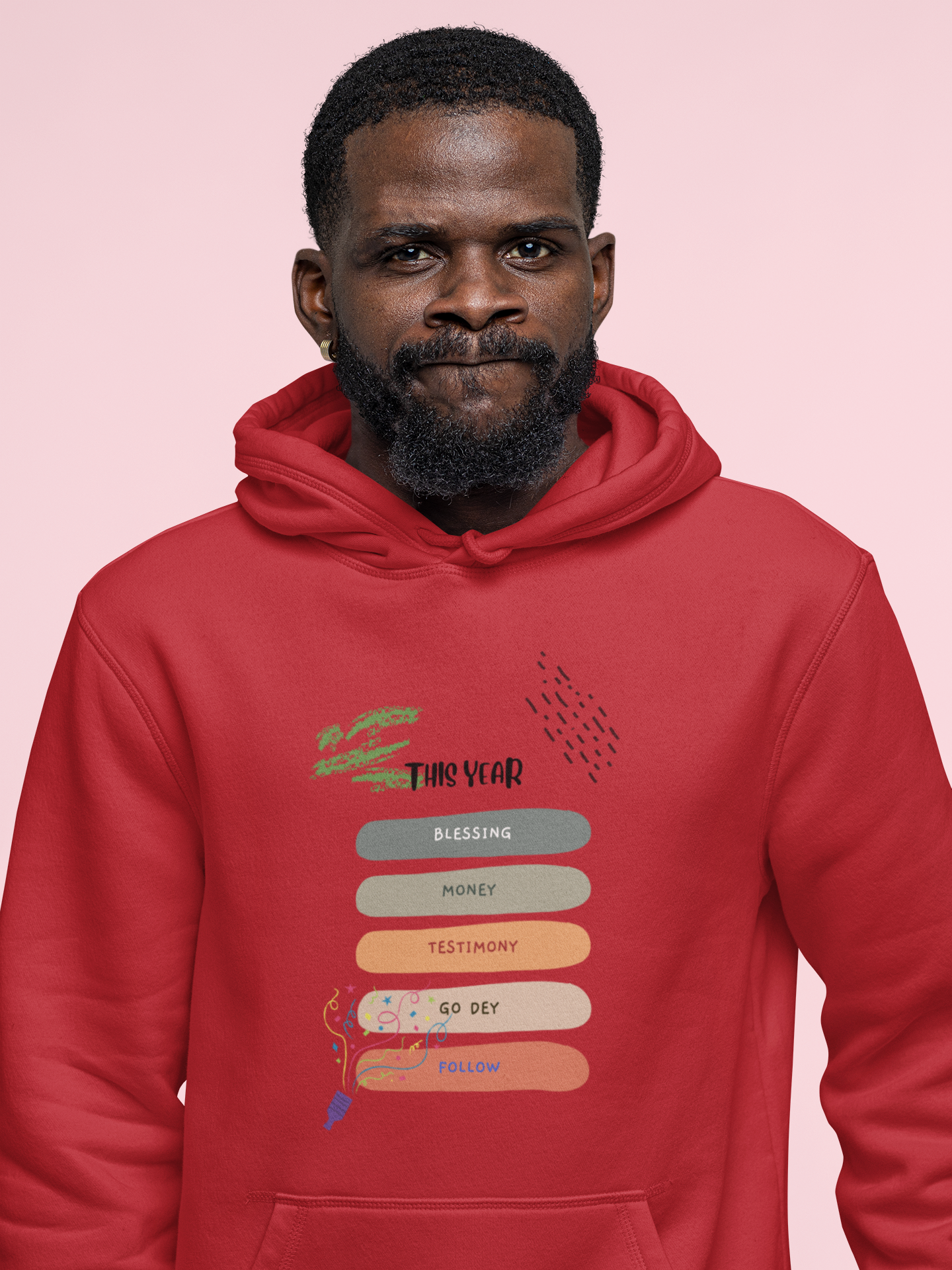 Man wearing a red hoodie with text design on a pink background
