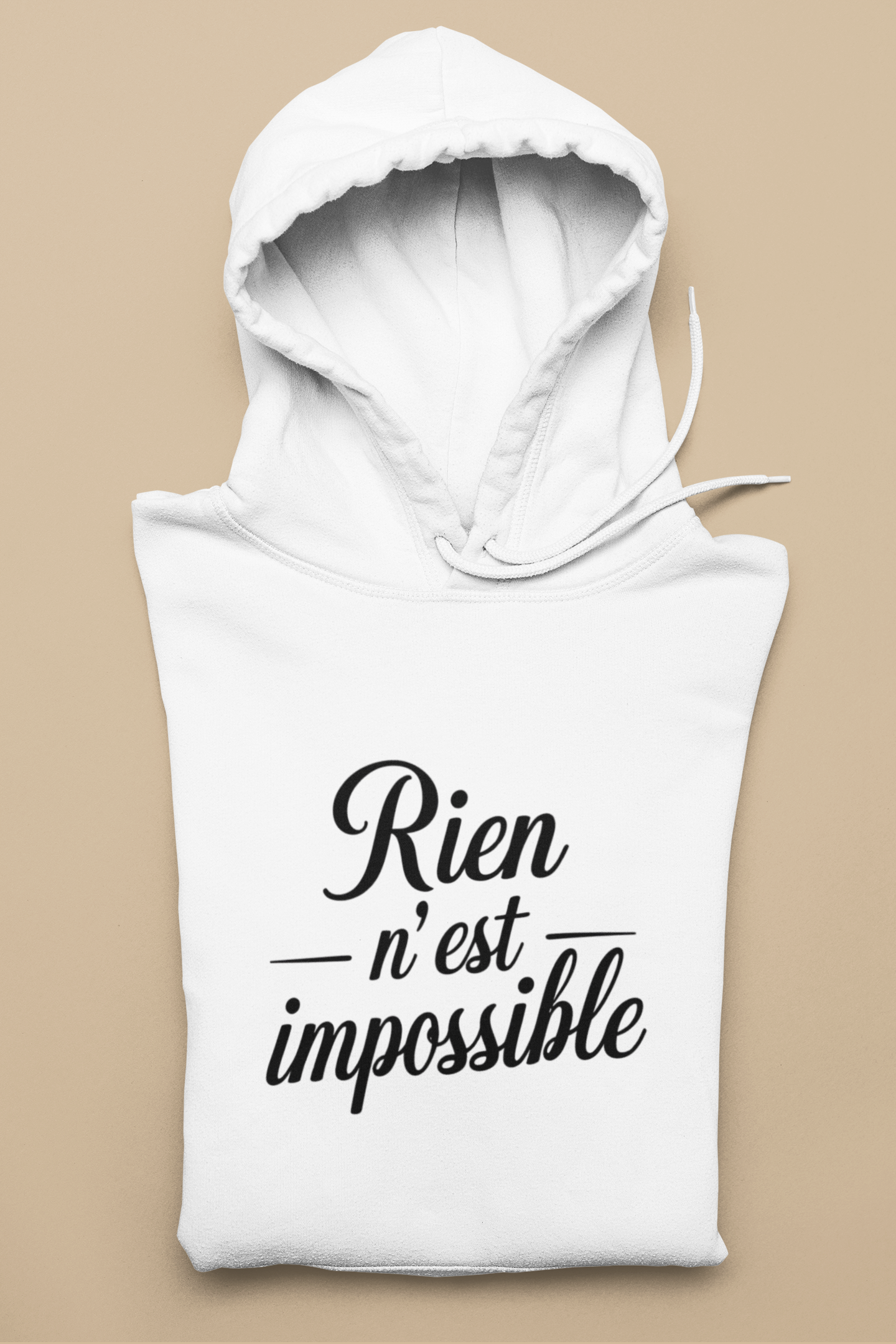 White sleeveless hoodie with 'Rien n'est impossible' text on a beige background
