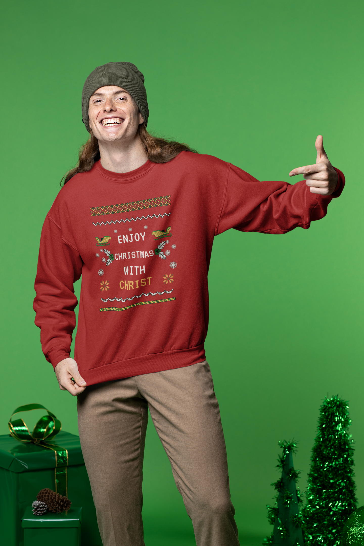 Person wearing a red Christmas sweater with text, standing against a green background