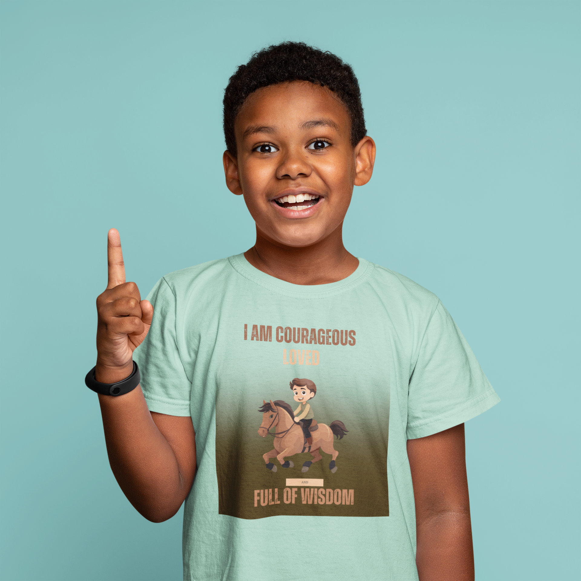 Child wearing a t-shirt with a graphic and text, pointing upwards against a light blue background