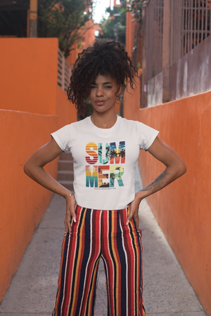 Person wearing a white t-shirt with 'SUMMER' in colorful letters against an orange wall.
