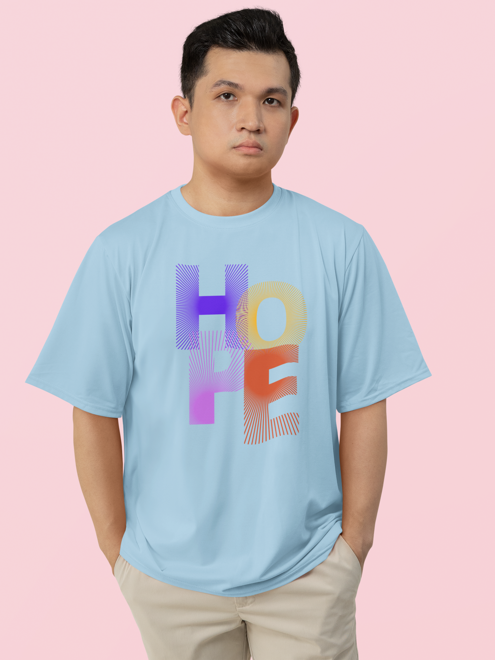 Person wearing a light blue t-shirt with 'HOPE' in colorful letters on a pink background
