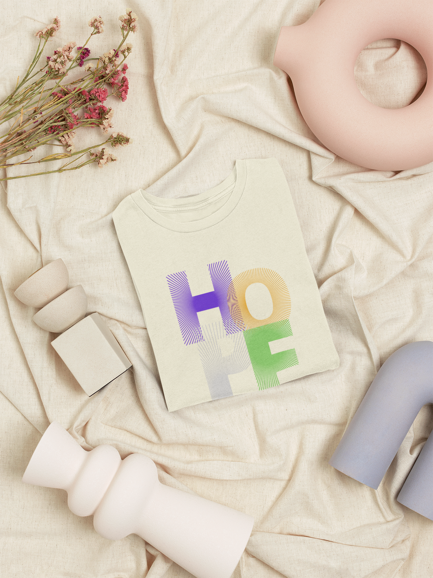 Baby t-shirt with 'HOPE' print on a soft beige fabric background