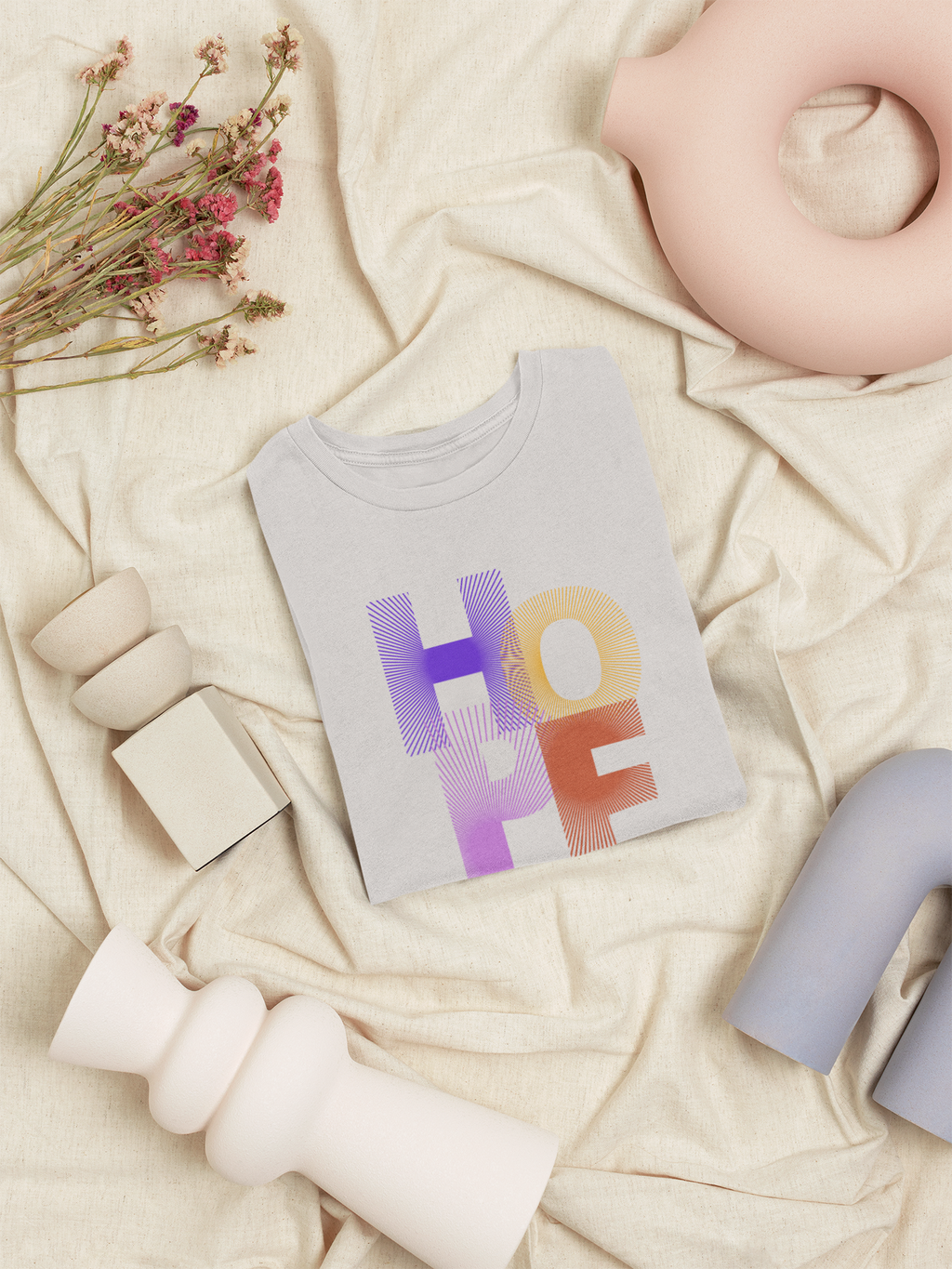 Baby t-shirt with 'HOPE' print on a soft beige background