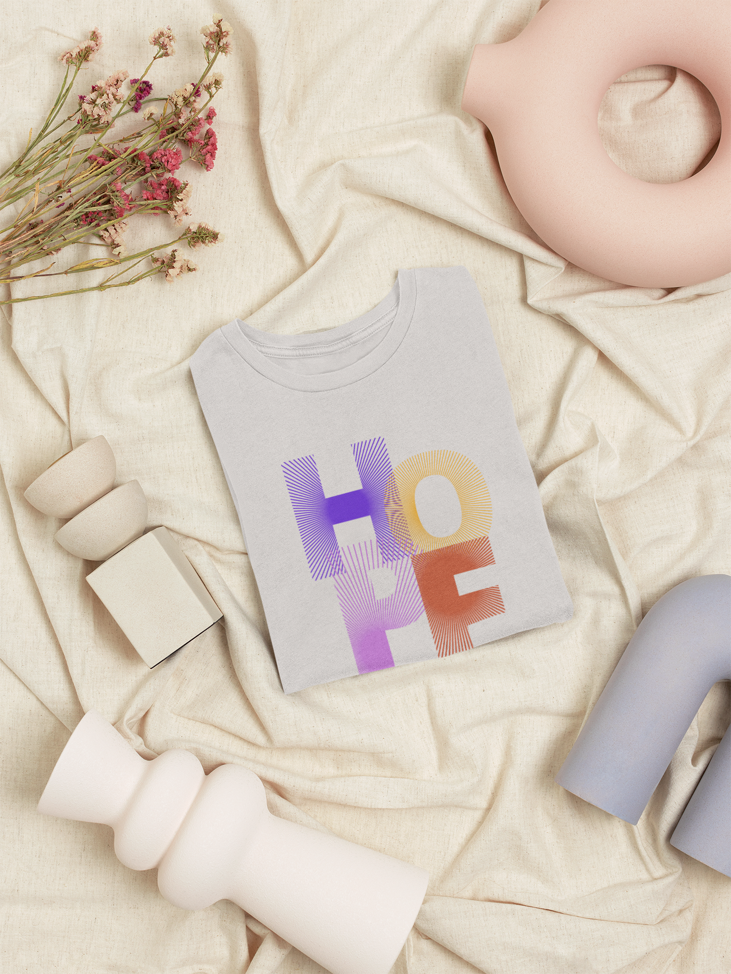 Baby t-shirt with 'HOPE' print on a soft beige background