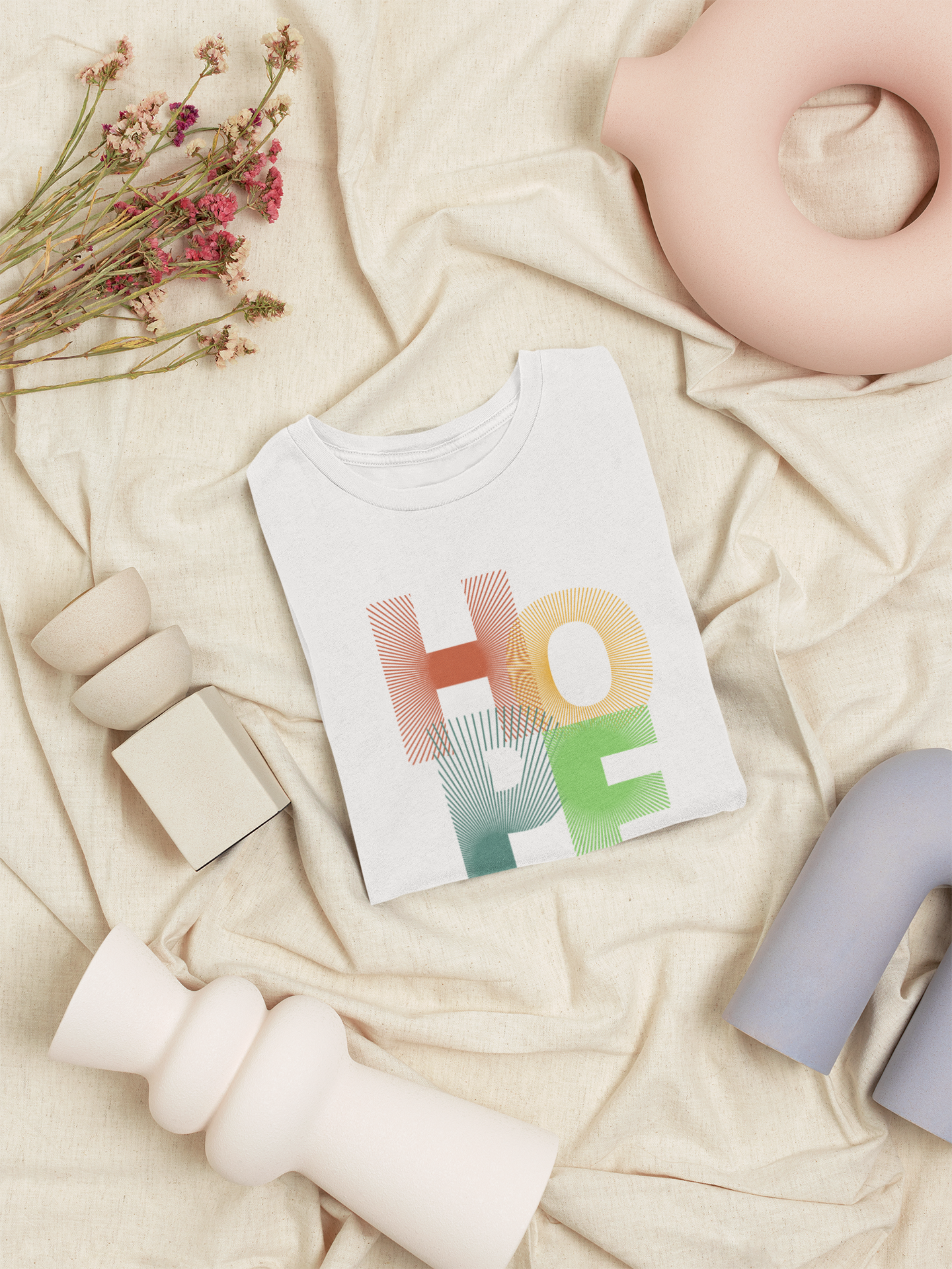 Colorful 'HOPE' card on a soft beige surface with decorative elements.