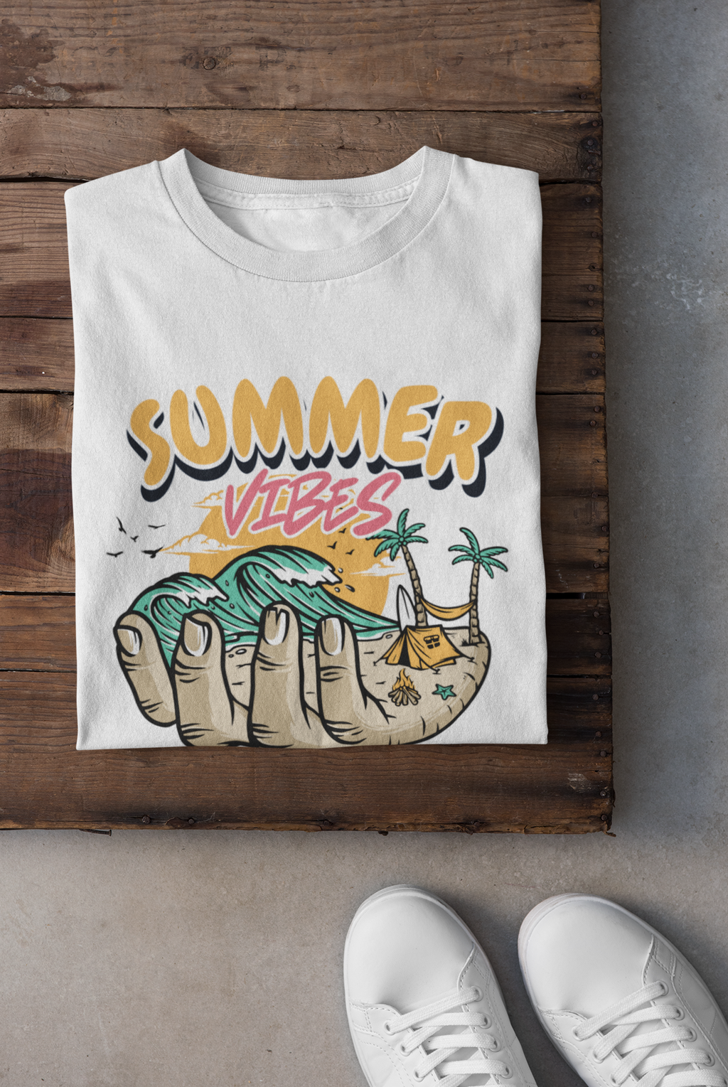 White t-shirt with 'Summer Vibes' design on a wooden surface