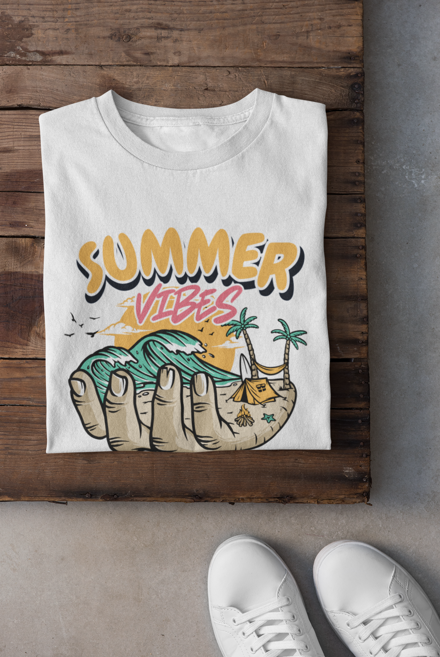 White t-shirt with 'Summer Vibes' design on a wooden surface